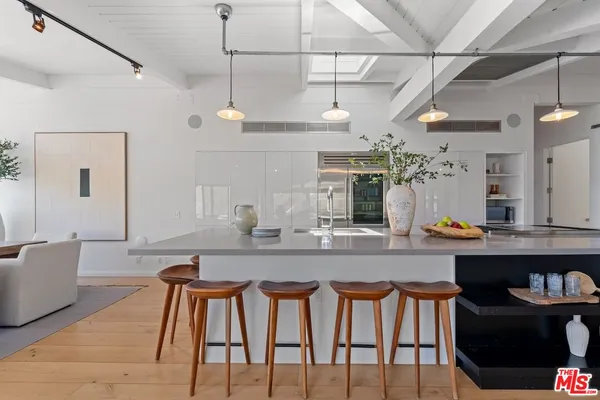 a dining table with chairs and cabinets