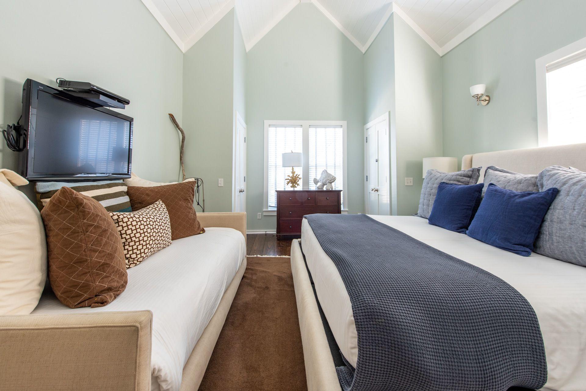 287 Salt Lane Watersound, FL 32461 - Photo 12 of 38 a bedroom with bed and glass windows