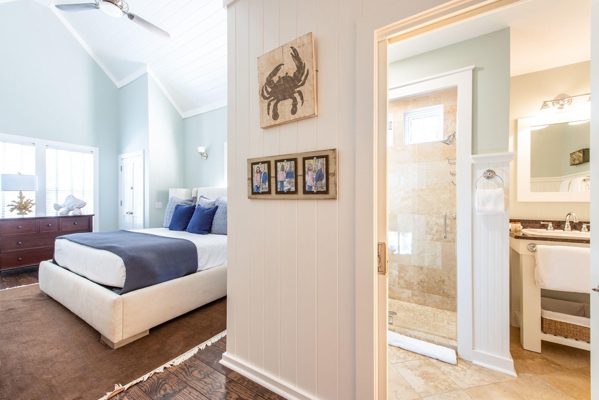 287 Salt Lane Watersound, FL 32461 - Photo 13 of 38 a spacious bedroom with a bed and a walk in closet