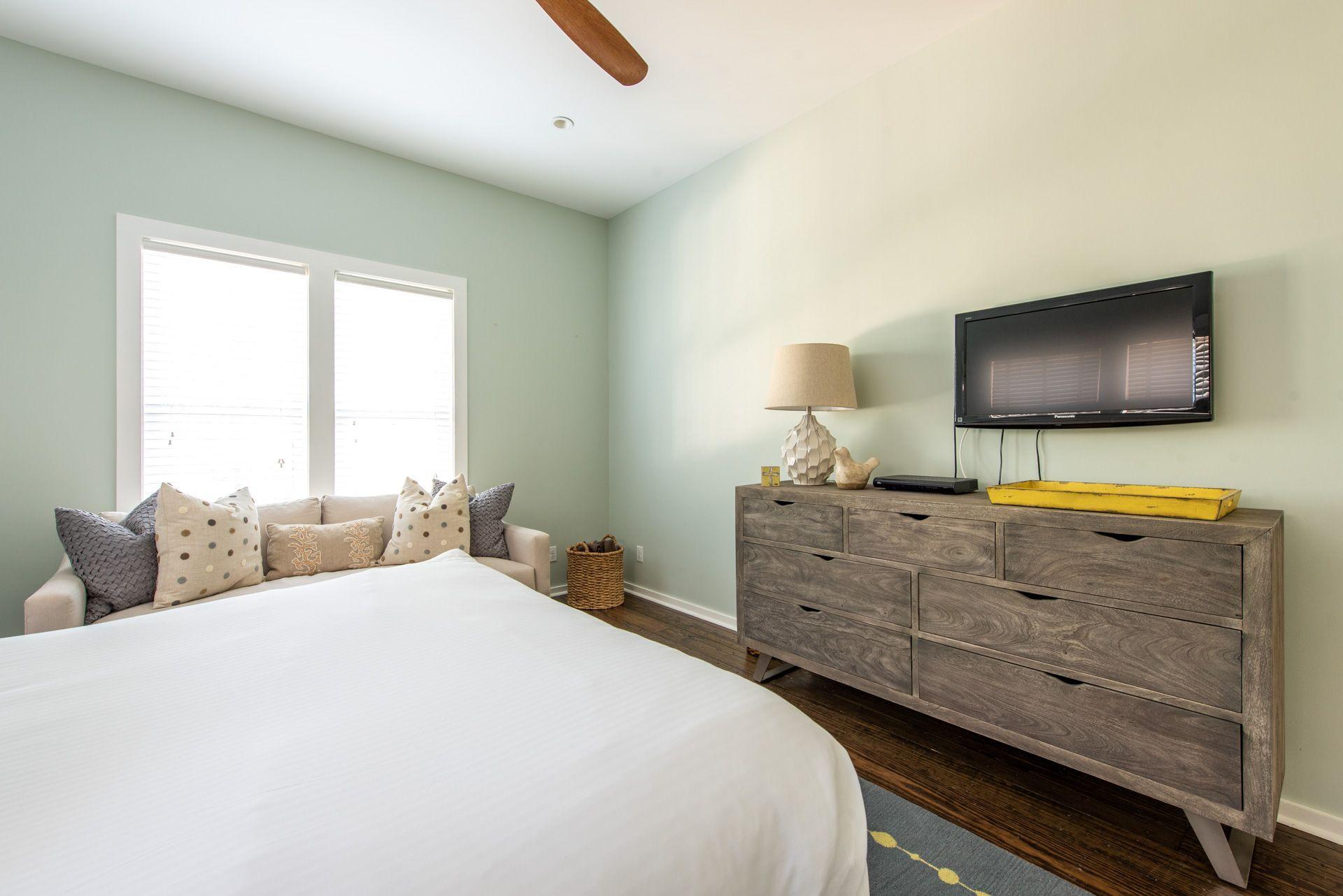 287 Salt Lane Watersound, FL 32461 - Photo 19 of 38 a bedroom with a bed and a flat screen tv