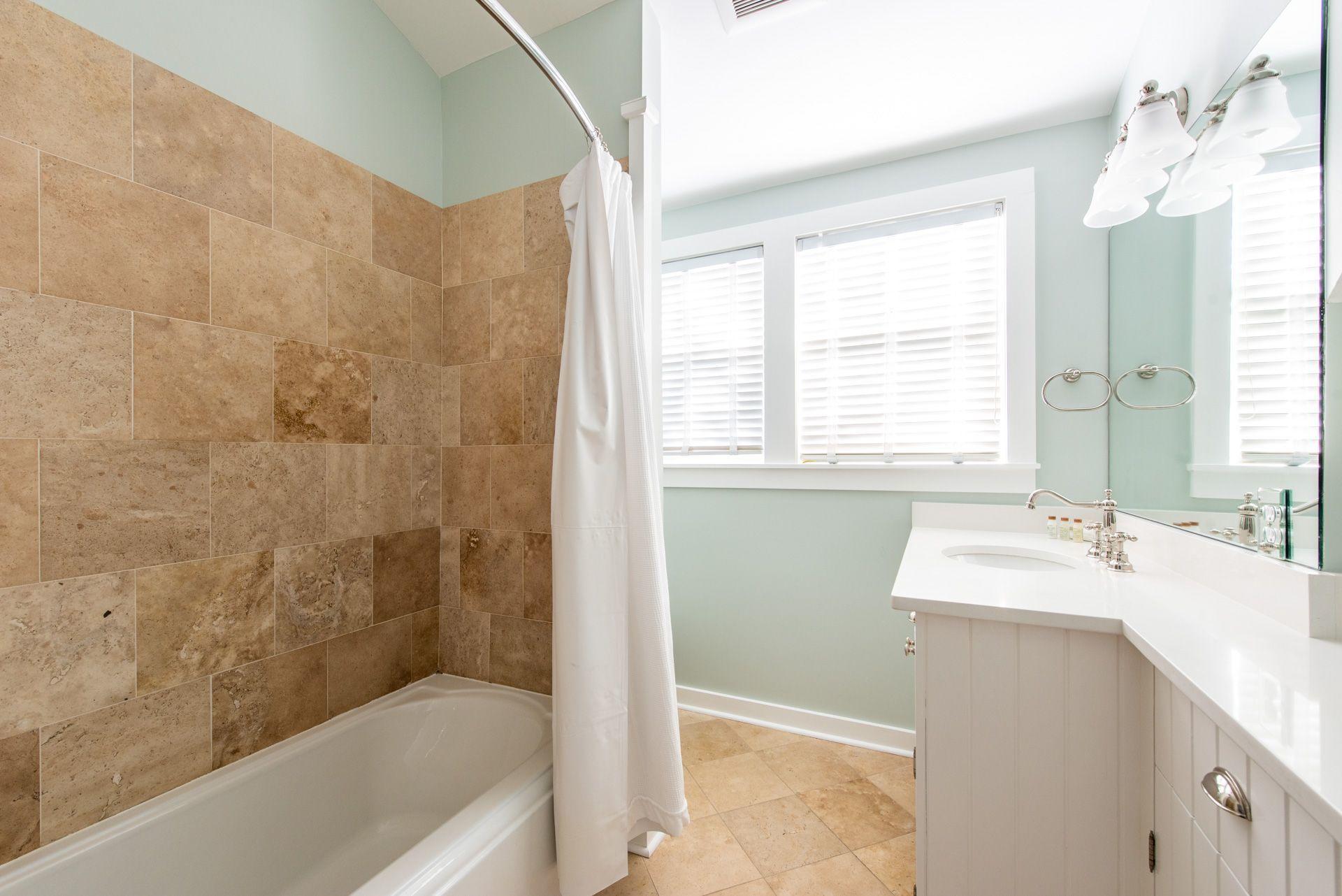 287 Salt Lane Watersound, FL 32461 - Photo 23 of 38 a bathroom with a granite countertop sink mirror bathtub and shower