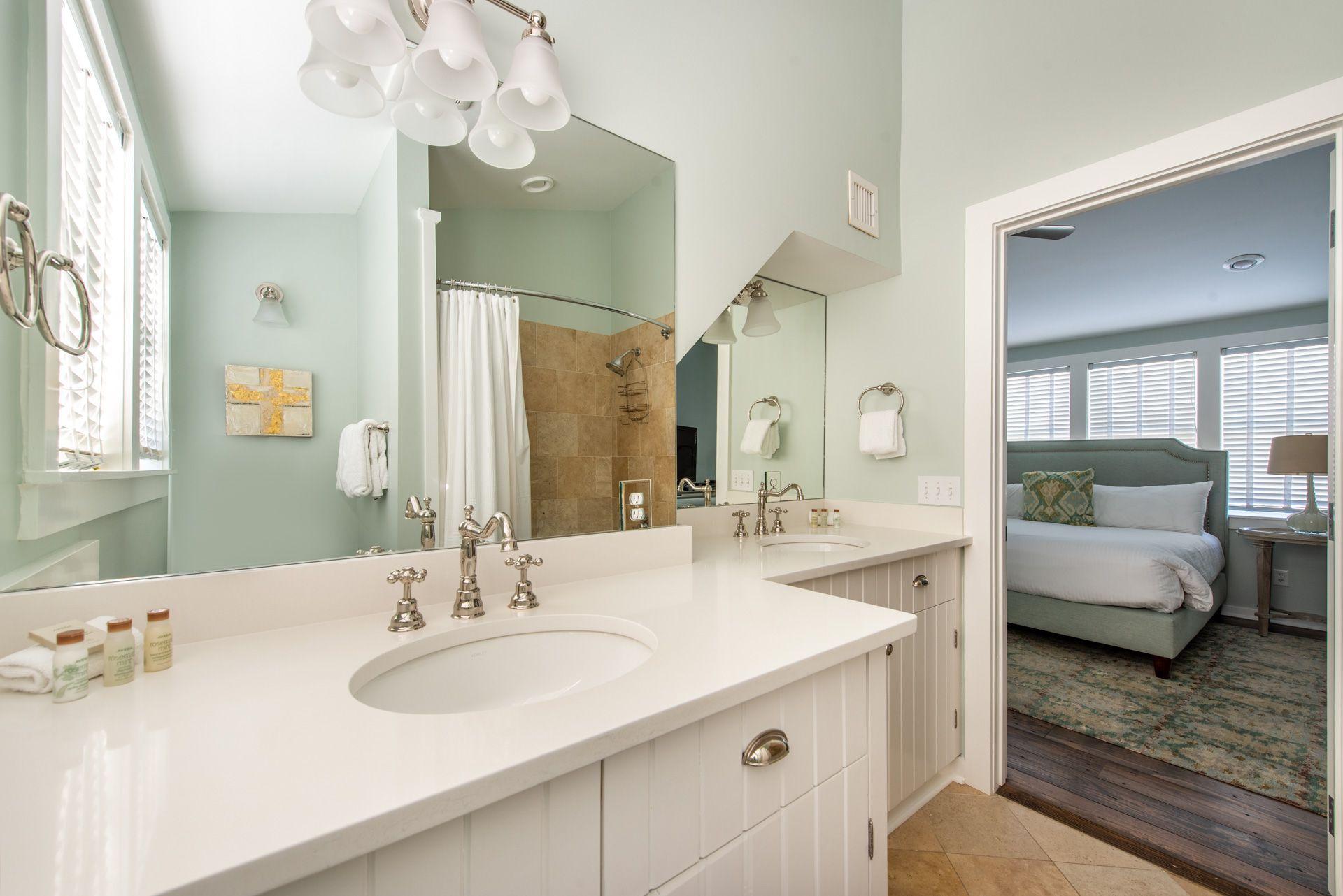 287 Salt Lane Watersound, FL 32461 - Photo 24 of 38 a bathroom with a sink a large mirror and a bathtub