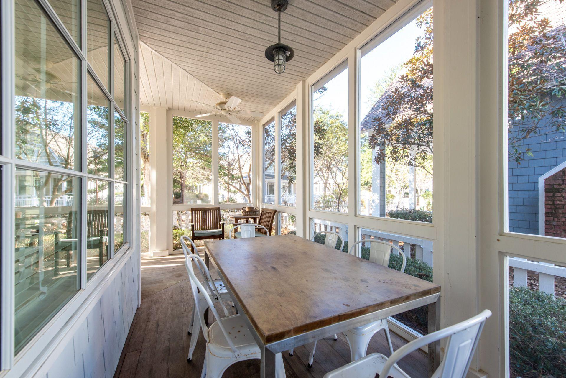 287 Salt Lane Watersound, FL 32461 - Photo 30 of 38 a dining room with furniture large windows and wooden floor
