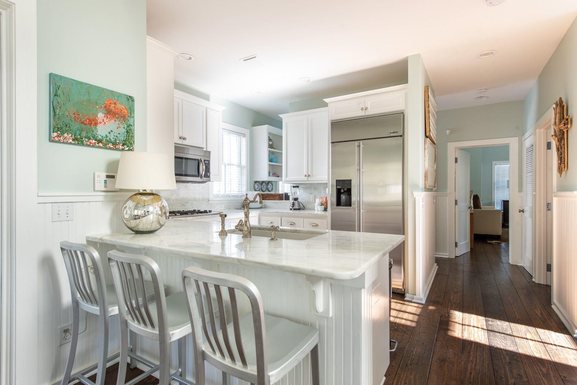 287 Salt Lane Watersound, FL 32461 - Photo 5 of 38 a kitchen with stainless steel appliances granite countertop a dining table chairs refrigerator and sink