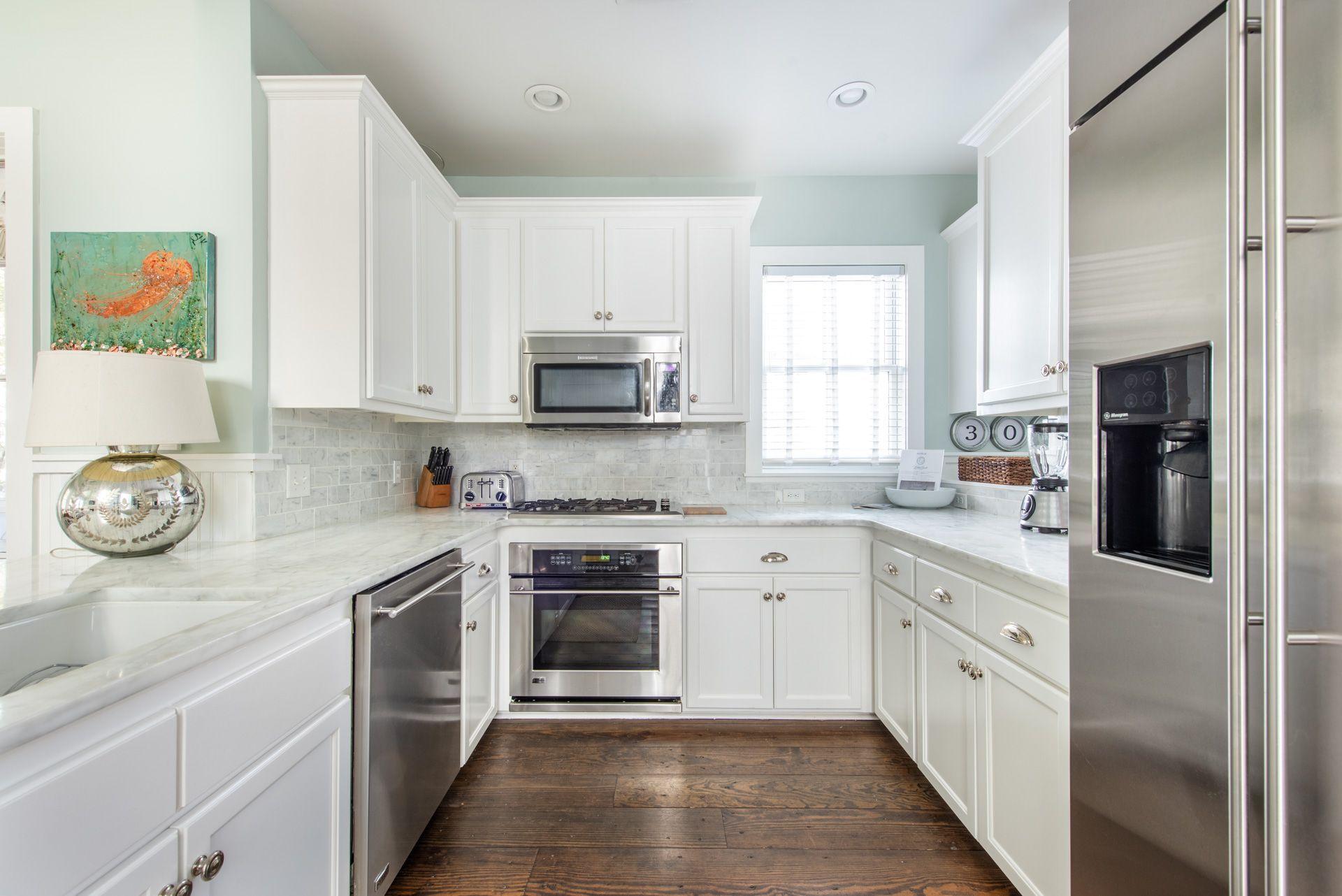 287 Salt Lane Watersound, FL 32461 - Photo 8 of 38 a large kitchen with cabinets stainless steel appliances and a window