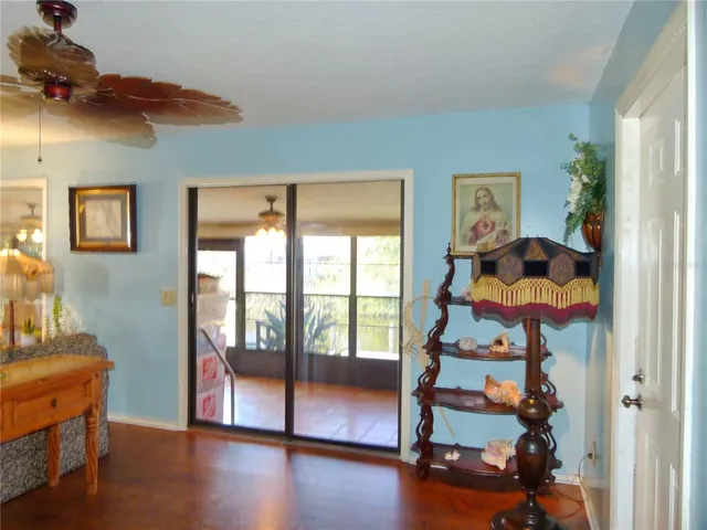 a living room with dining room and wooden floor