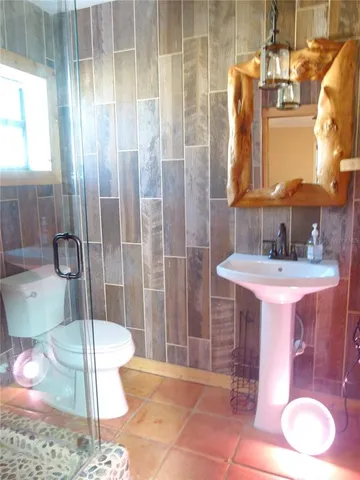 a bathroom with a toilet and a shower