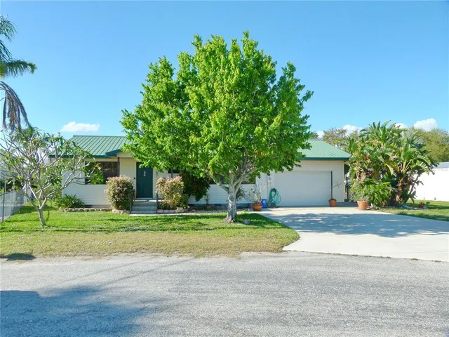 a front view of a house with a yard and a garage