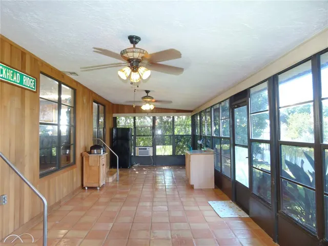 a view of a dining room with furniture a chandelier and wooden floor
