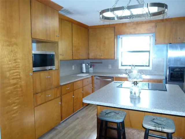 a kitchen with a table and chairs