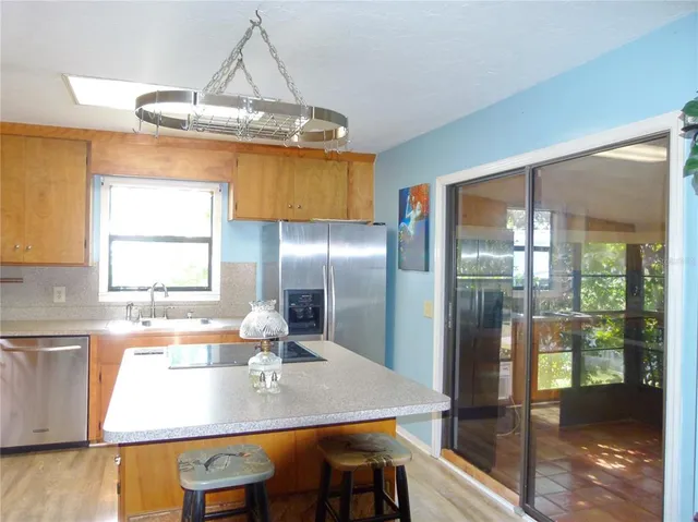 a kitchen with a sink a stove and a microwave