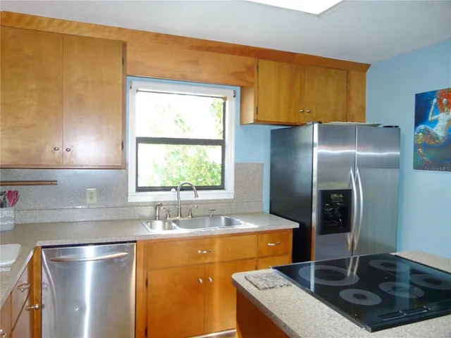 a kitchen with a sink cabinets and window