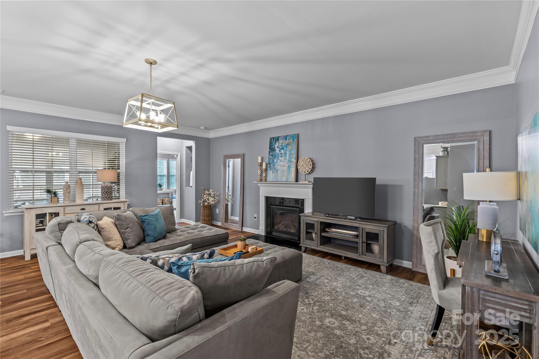 8097 Asher Chase Trail Lancaster, SC 29720 - Photo 15 of 47 a living room with furniture a chandelier a rug and a window