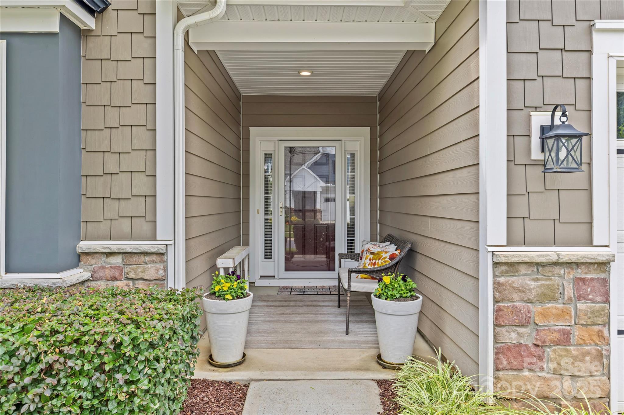 8097 Asher Chase Trail Lancaster, SC 29720 - Photo 2 of 47 a view of a entryway door front of house and potted plants