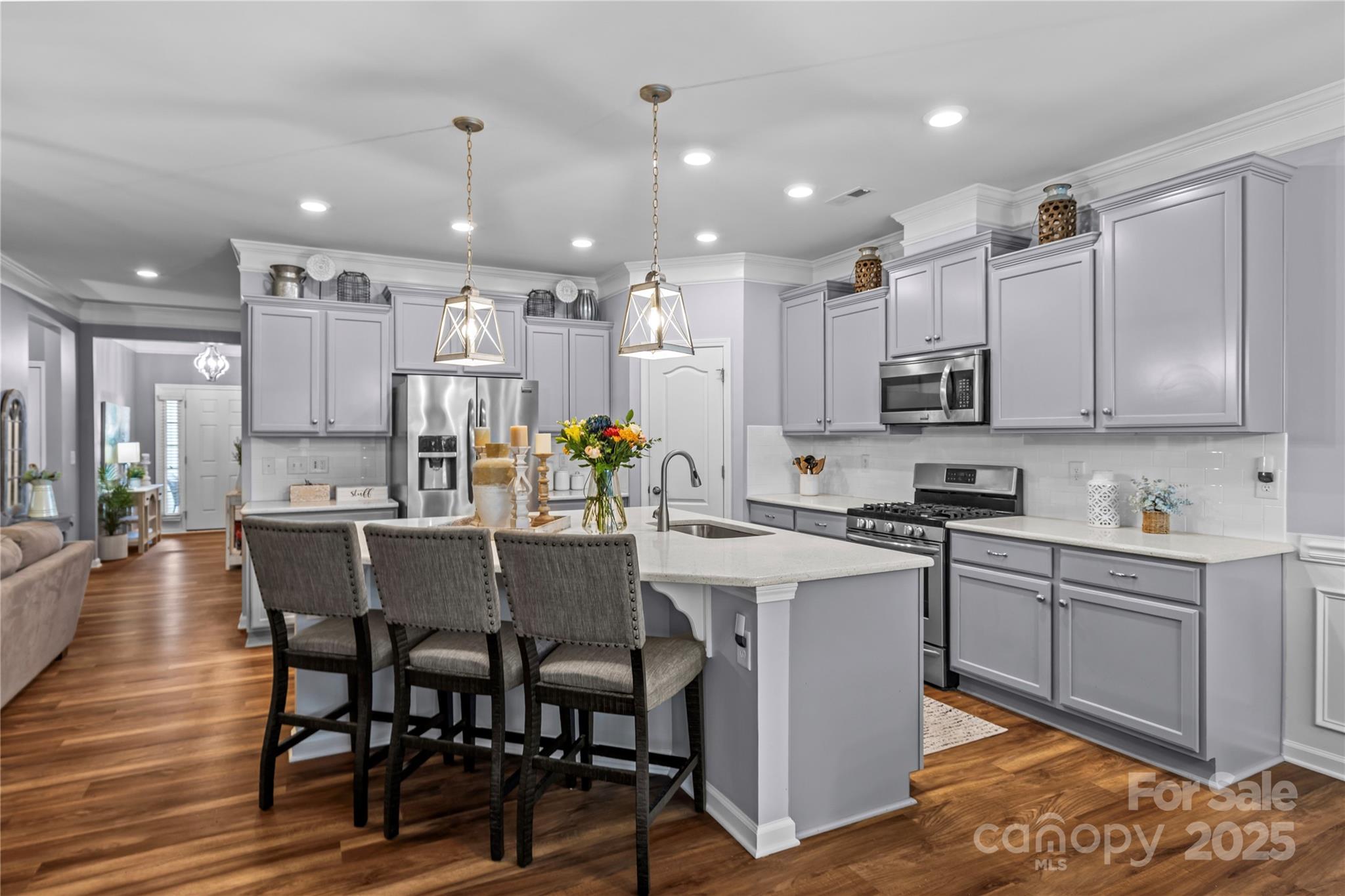 8097 Asher Chase Trail Lancaster, SC 29720 - Photo 6 of 47 a kitchen with kitchen island granite countertop a dining table chairs and white cabinets