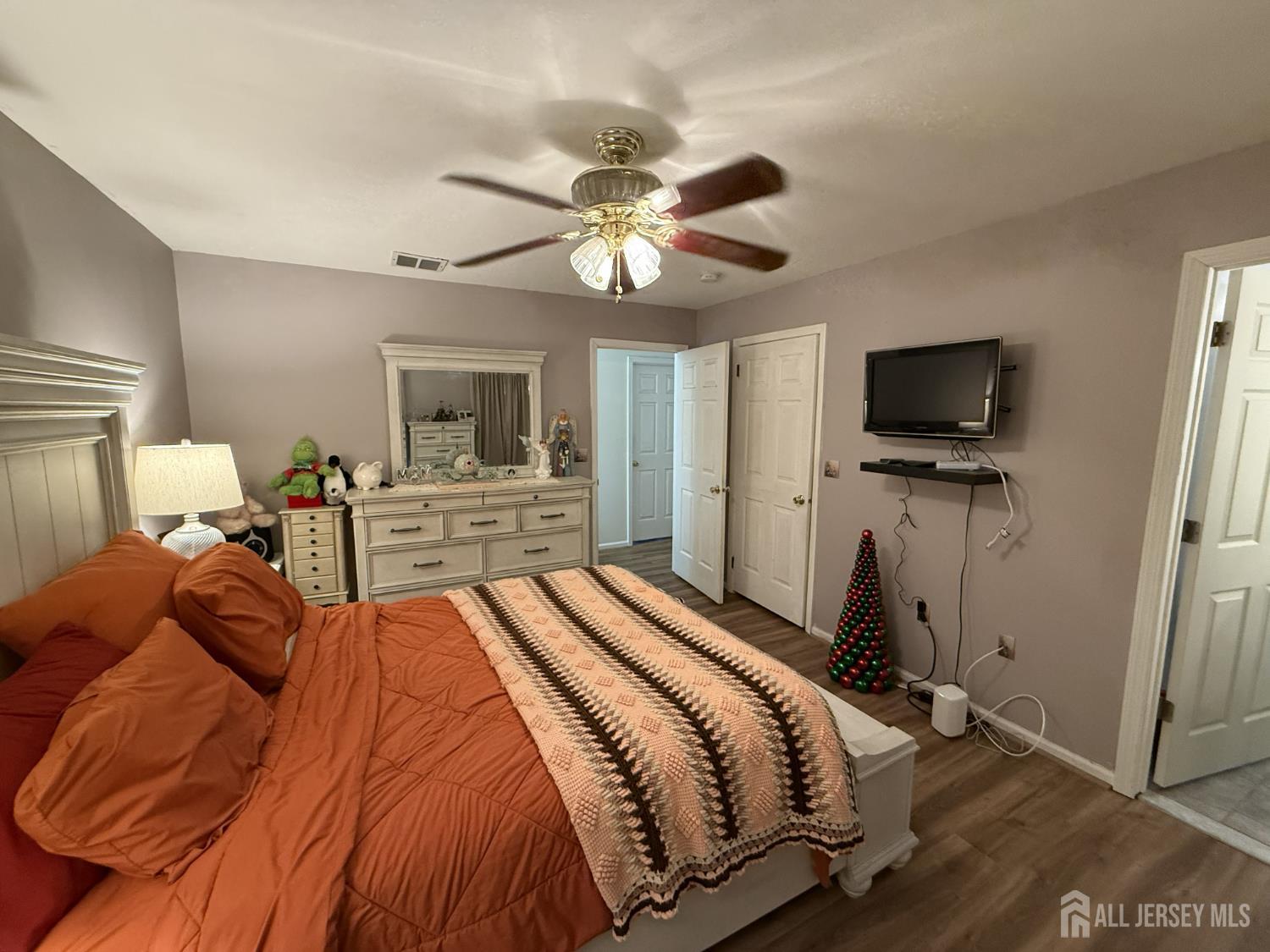 15 Sutton Place Helmetta, NJ 08828 - Photo 15 of 27 a bedroom with a bed and a flat tv screen on the dresser