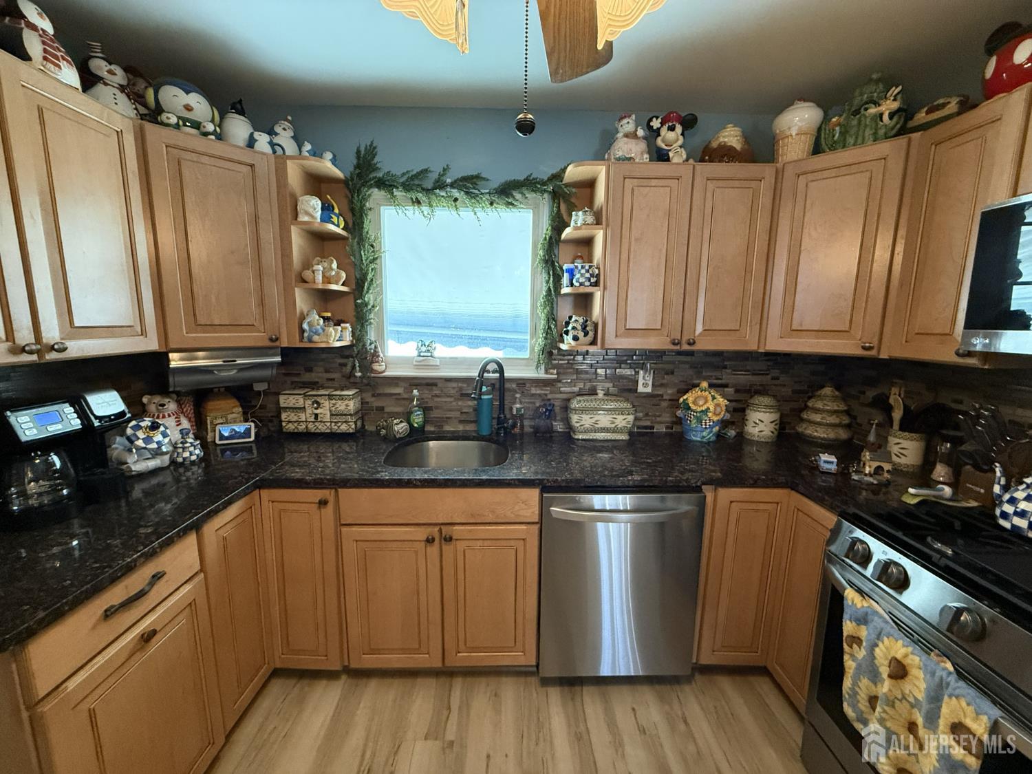 15 Sutton Place Helmetta, NJ 08828 - Photo 7 of 27 a kitchen with granite countertop a sink cabinets and stainless steel appliances