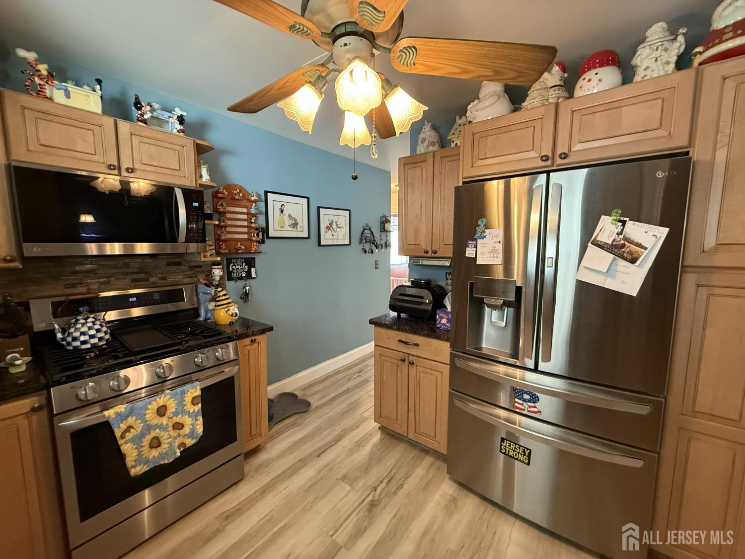 15 Sutton Place Helmetta, NJ 08828 - Photo 8 of 27 a kitchen with stainless steel appliances a stove a refrigerator and a microwave