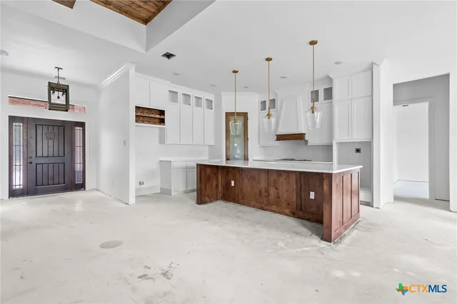 a large bathroom with a granite countertop double vanity sink a mirror and shower