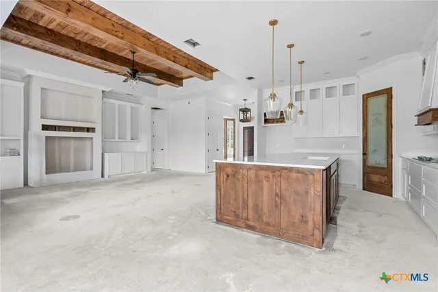 a view of a kitchen with stainless steel appliances granite countertop a refrigerator a oven a sink and dishwasher