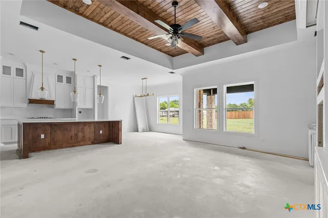 a view of an empty room with a kitchen