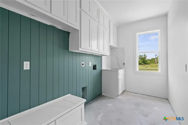 a view of an empty room with closet and entryway