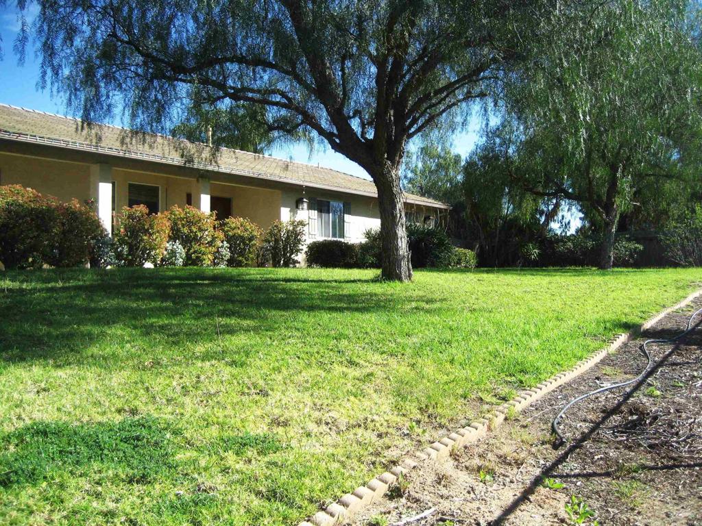 29175 The Yellow Brick Road Valley Center, CA 92082 - Photo 1 of 17 a front view of a house with a yard