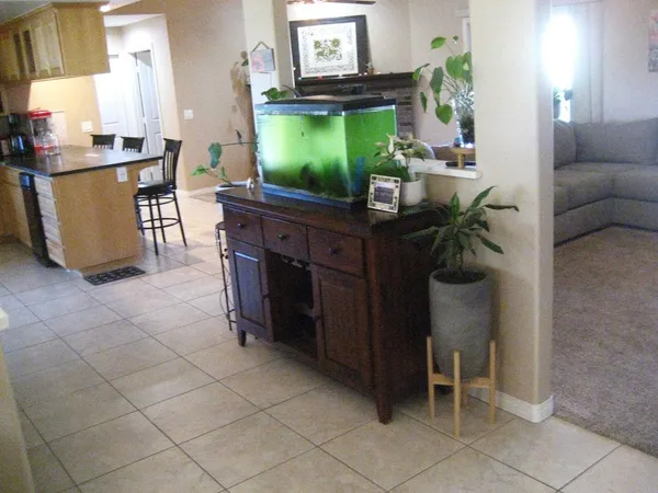 a living room with furniture a flat screen tv and a dining table