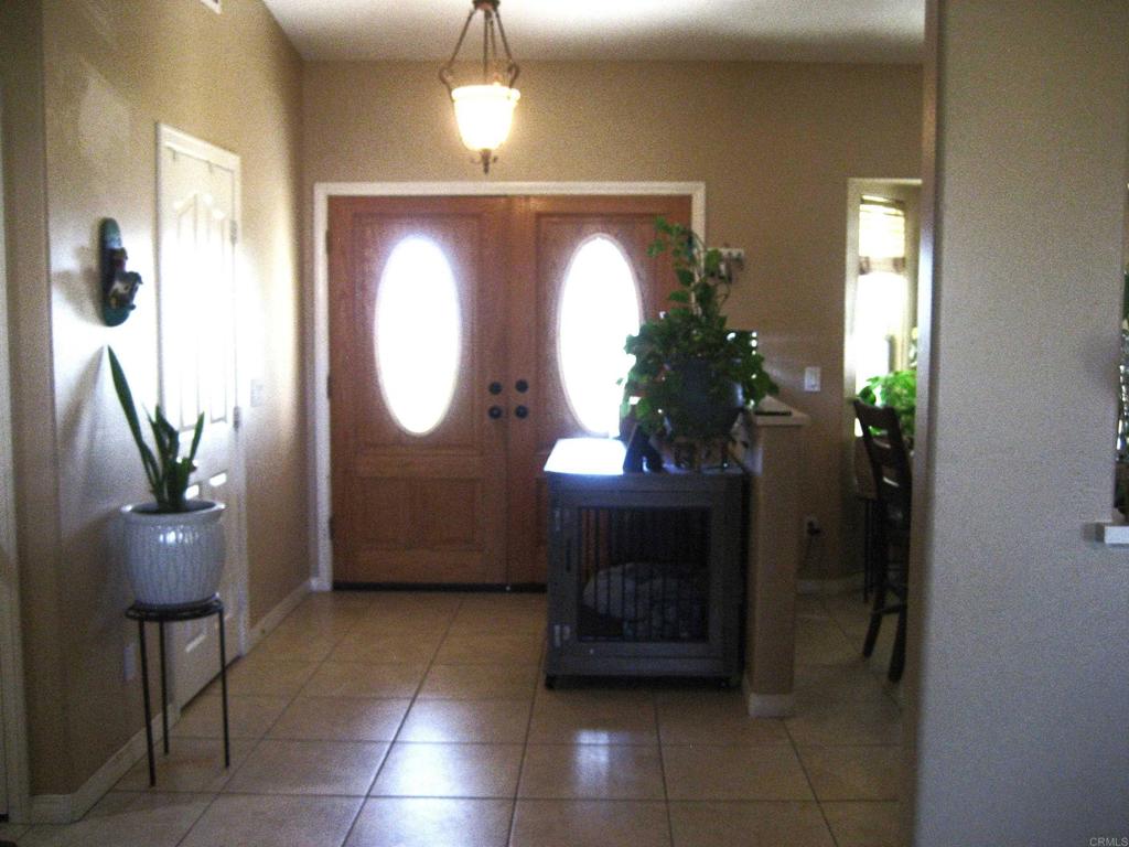 29175 The Yellow Brick Road Valley Center, CA 92082 - Photo 10 of 17 a living room with furniture a potted plant a lamp and entryway