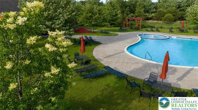 a group of people sitting on green field in front of building