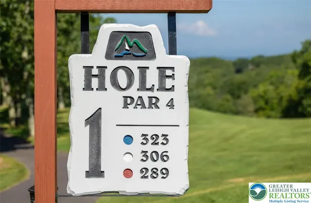 a living room with furniture a chandelier and a large window
