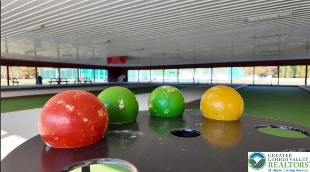 a view of a swimming pool with a yard and sitting area