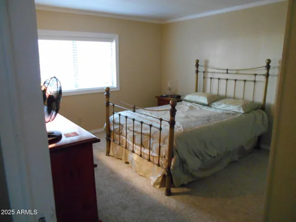 a bedroom with a bed and window
