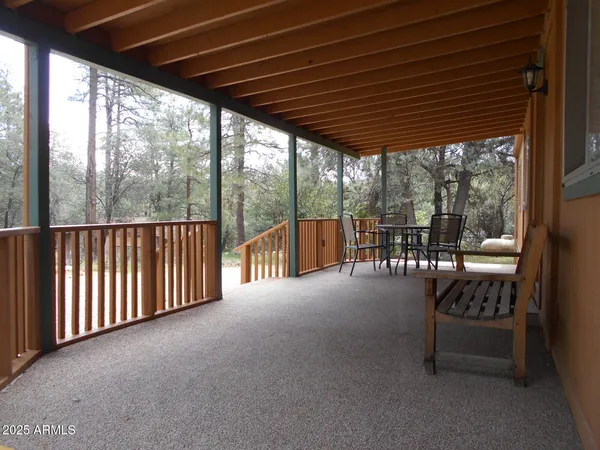 a view of porch with furniture and floor to ceiling window