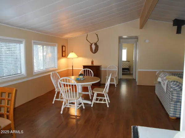 a dining room with furniture and wooden floor