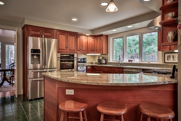 196 Middle Road Newbury, MA 01922 - Photo 8 of 28 a kitchen with stainless steel appliances granite countertop a stove a refrigerator a sink dishwasher with a dining table and chair with wooden floor