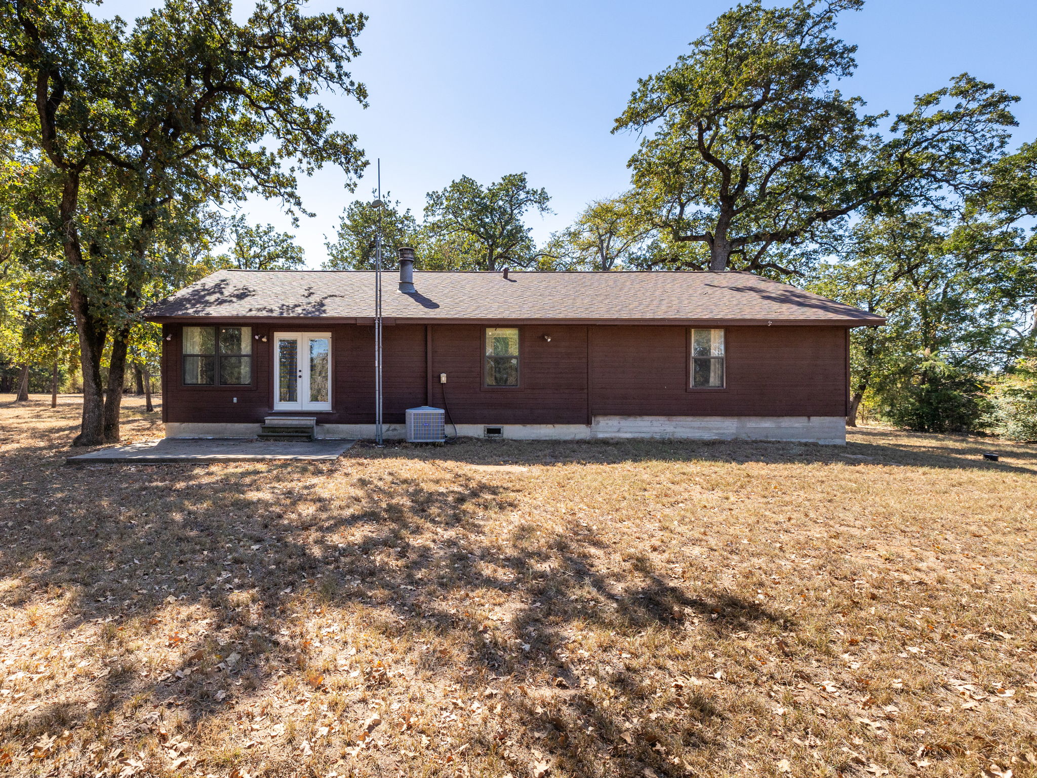 1949 County Road 347 Loop Gause, TX 77857 - Photo 24 of 32 a front view of a house with a yard and garage