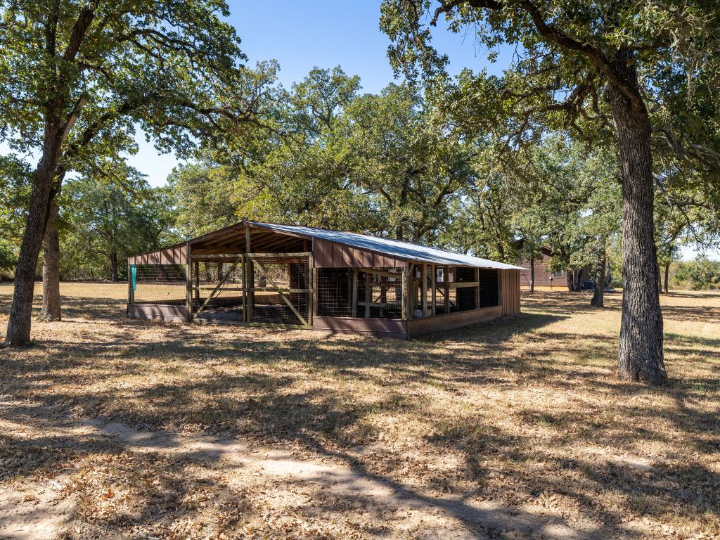 1949 County Road 347 Loop Gause, TX 77857 - Photo 28 of 32 a view of a house with large trees in the background