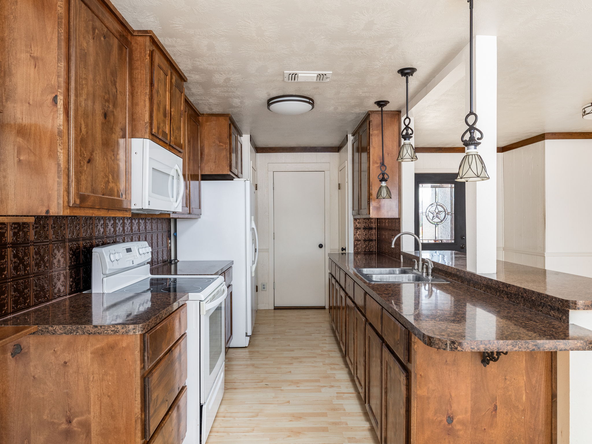 1949 County Road 347 Loop Gause, TX 77857 - Photo 7 of 32 a kitchen with stainless steel appliances granite countertop a sink stove and cabinets
