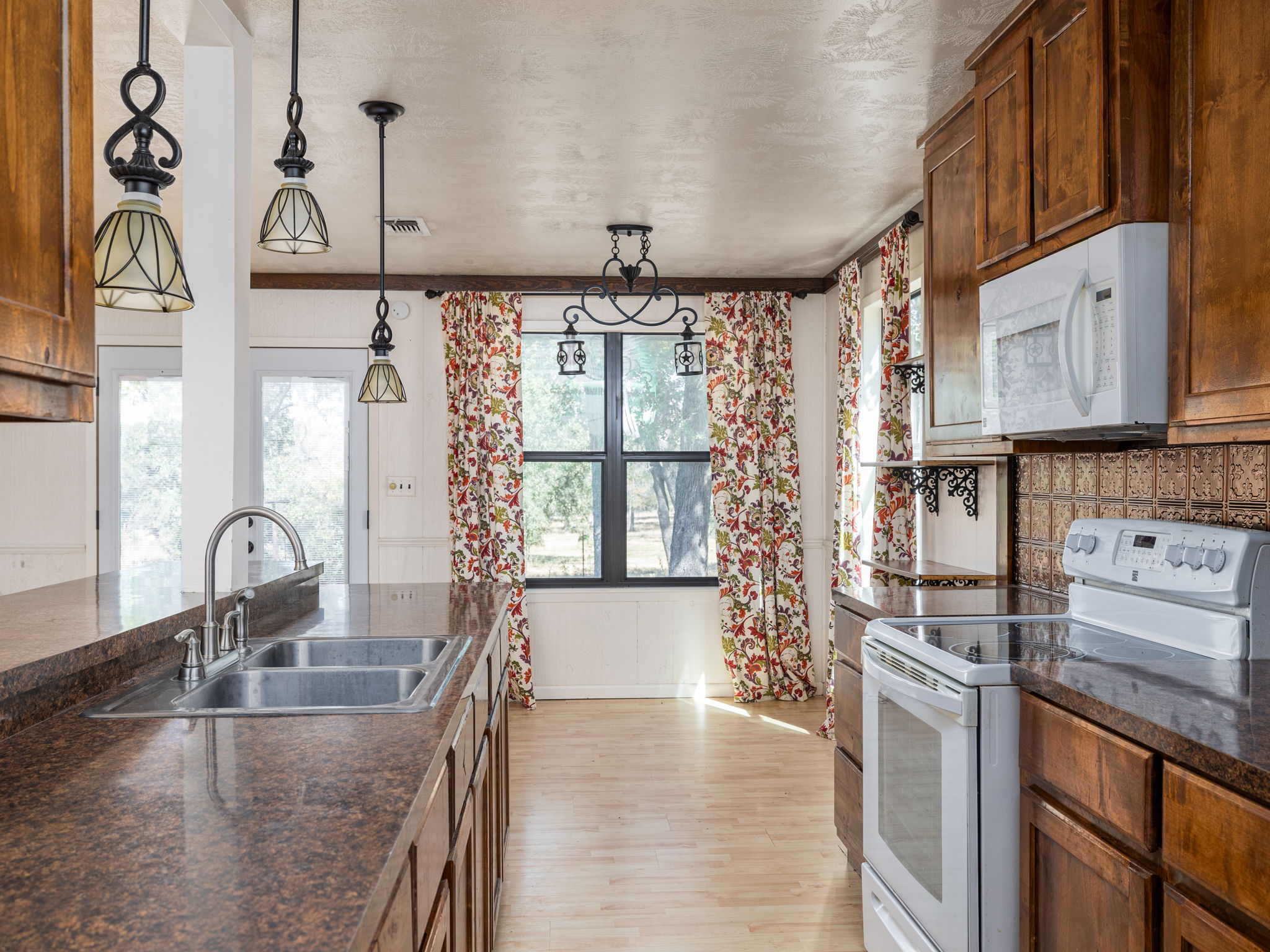 1949 County Road 347 Loop Gause, TX 77857 - Photo 8 of 32 a kitchen with stainless steel appliances granite countertop a sink a stove and a wooden floors
