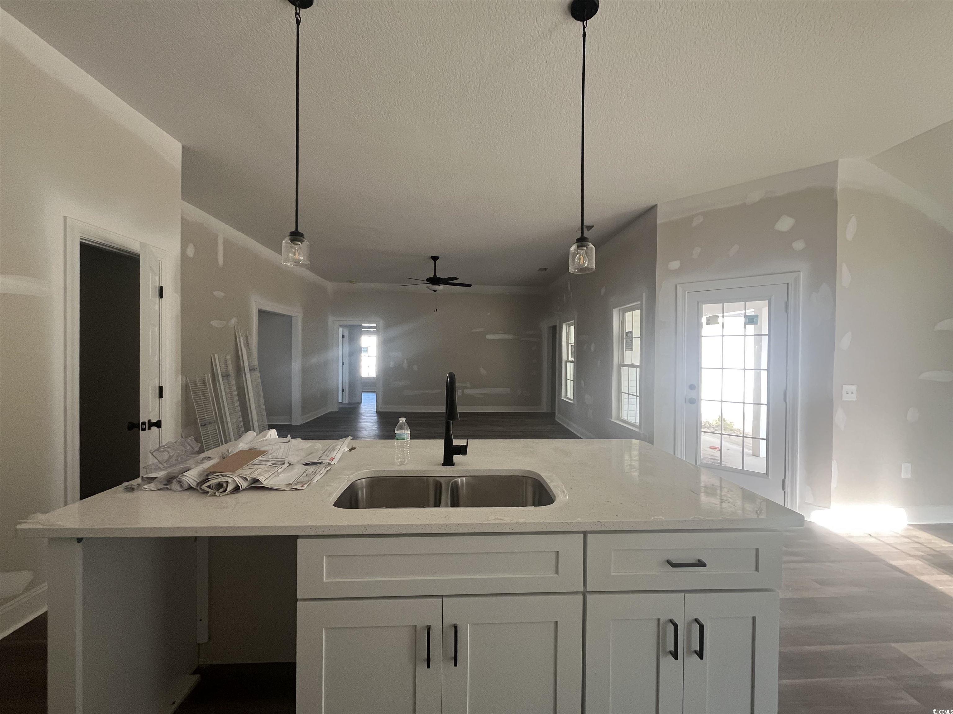 2921 Hughes Gasque Road Aynor, SC 29511 - Photo 4 of 14 Kitchen featuring a ceiling fan, dark wood finishe