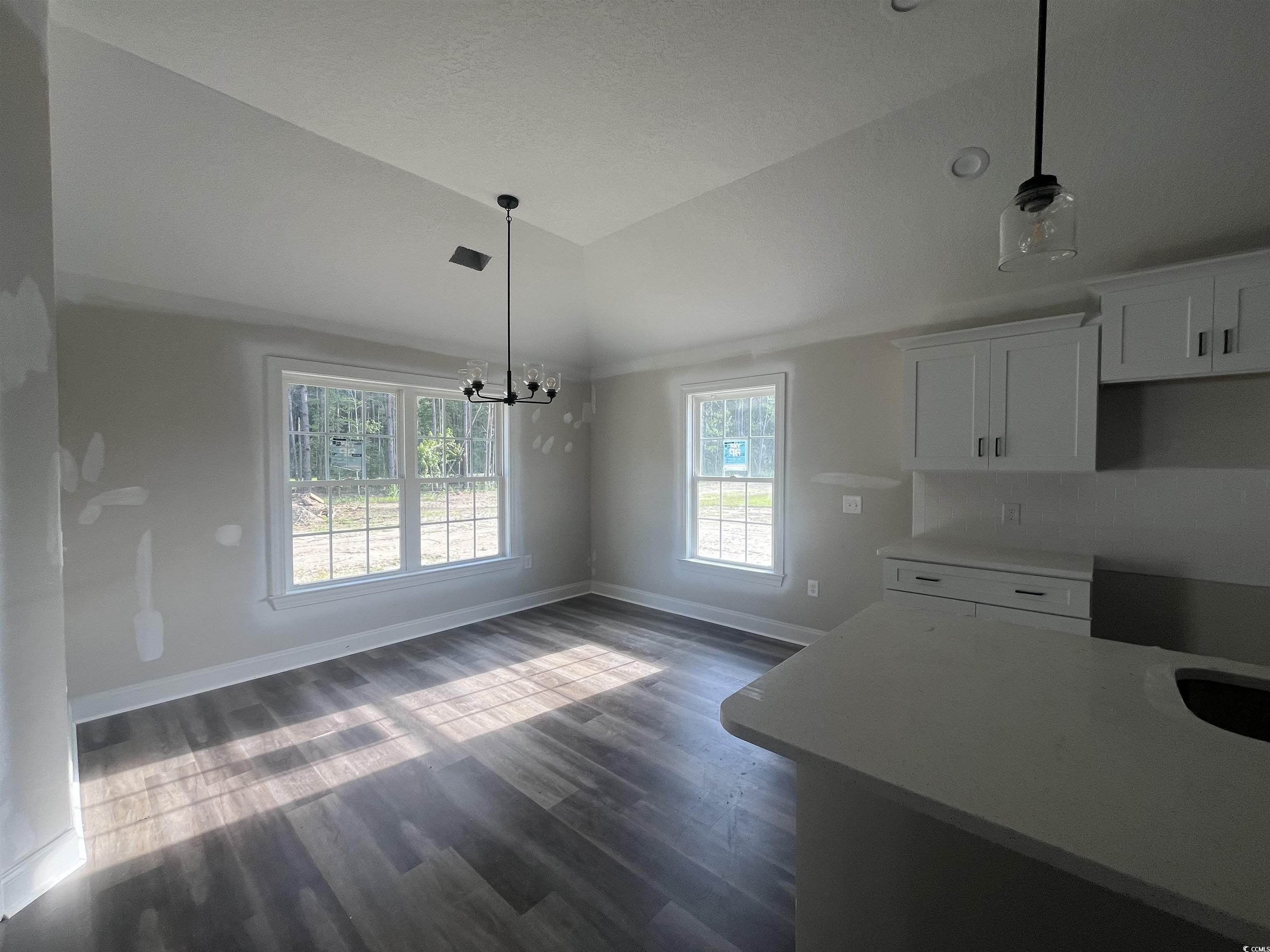 2921 Hughes Gasque Road Aynor, SC 29511 - Photo 5 of 14 Kitchen with lofted ceiling, white cabinetry, dark