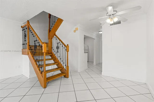 a view of front door with wooden floor and stairs