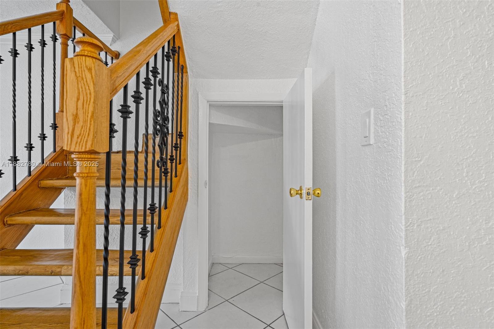 8650 Southwest 67th Avenue, Unit 1027 Pinecrest, FL 33156 - Photo 14 of 41 a view of front door with wooden floor and stairs