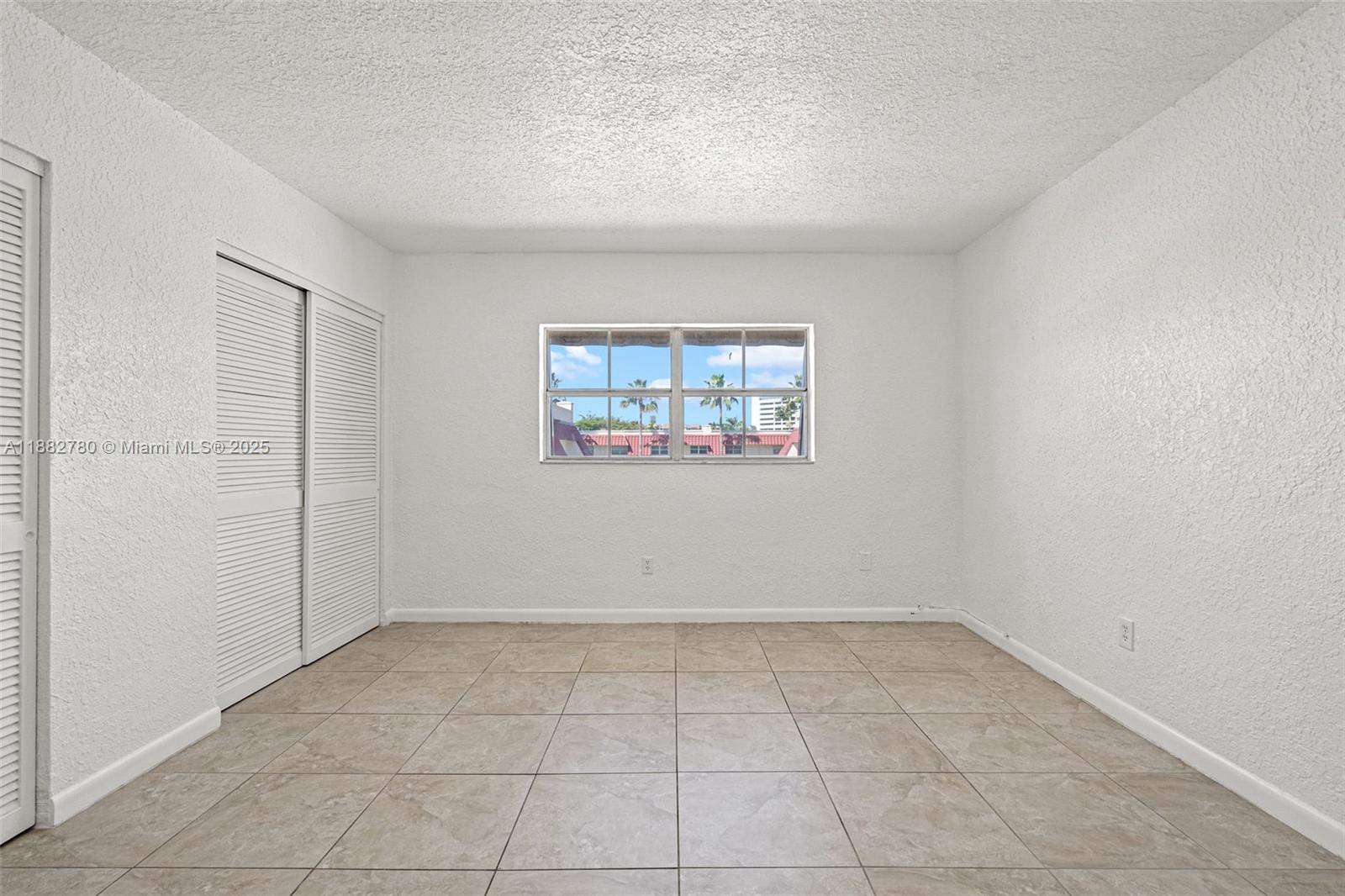 8650 Southwest 67th Avenue, Unit 1027 Pinecrest, FL 33156 - Photo 16 of 41 an empty room with a empty space and window