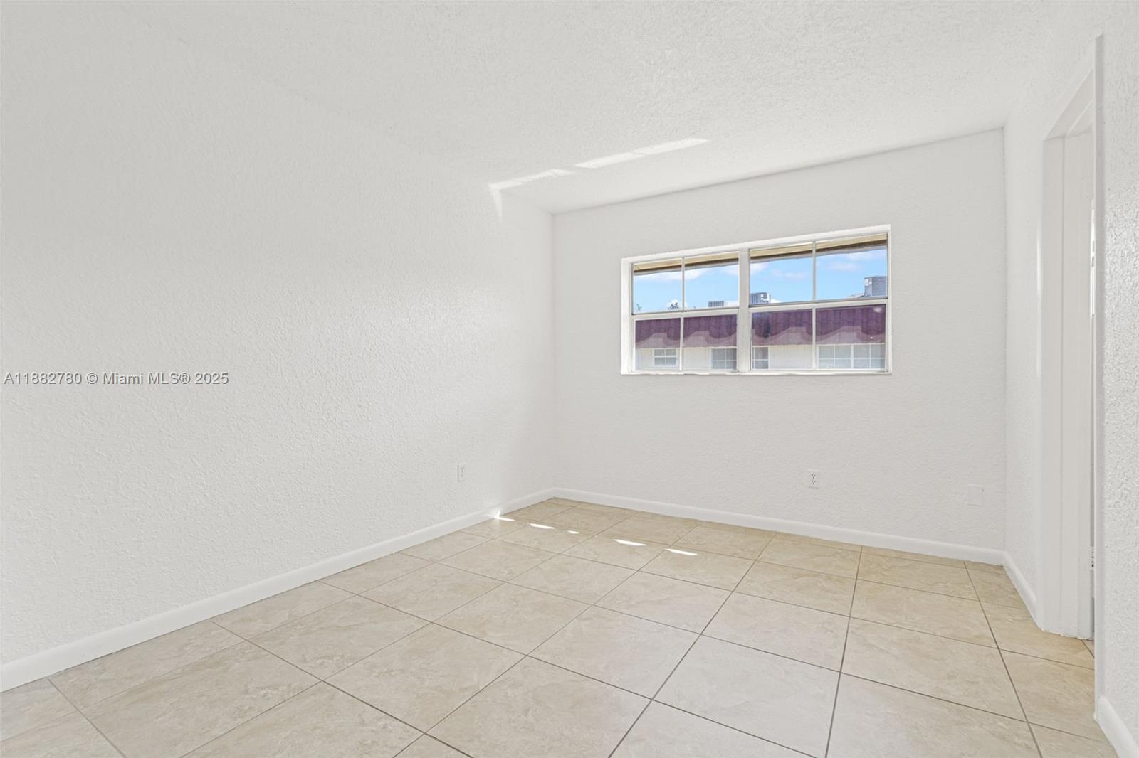 8650 Southwest 67th Avenue, Unit 1027 Pinecrest, FL 33156 - Photo 20 of 41 an empty room with windows