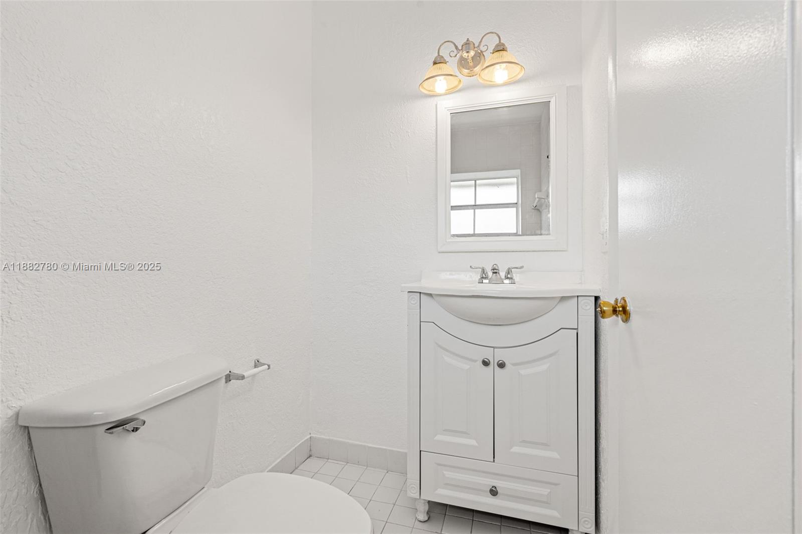 8650 Southwest 67th Avenue, Unit 1027 Pinecrest, FL 33156 - Photo 22 of 41 a bathroom with a sink a toilet and mirror