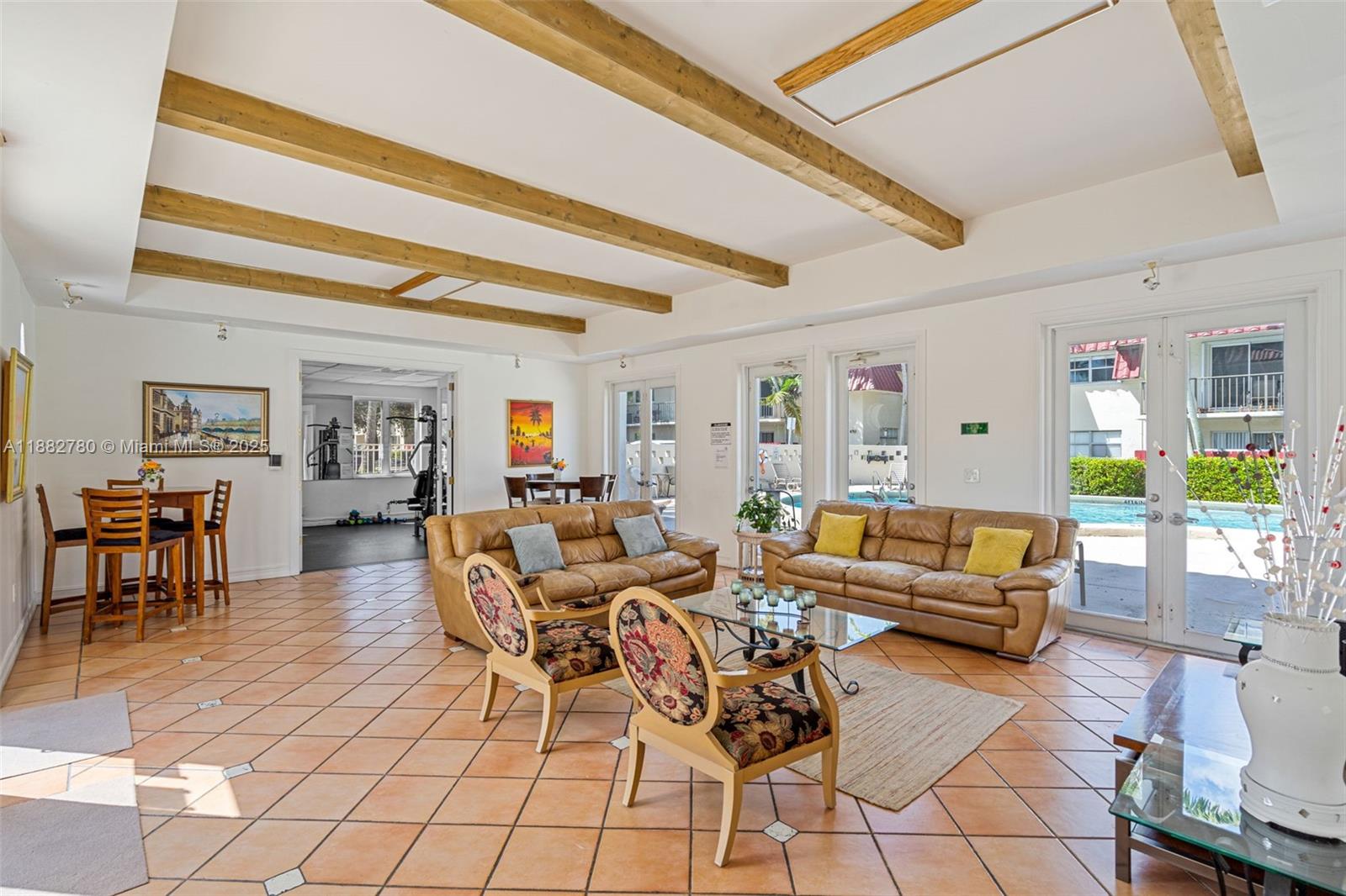 8650 Southwest 67th Avenue, Unit 1027 Pinecrest, FL 33156 - Photo 29 of 41 a living room with furniture and a floor to ceiling window