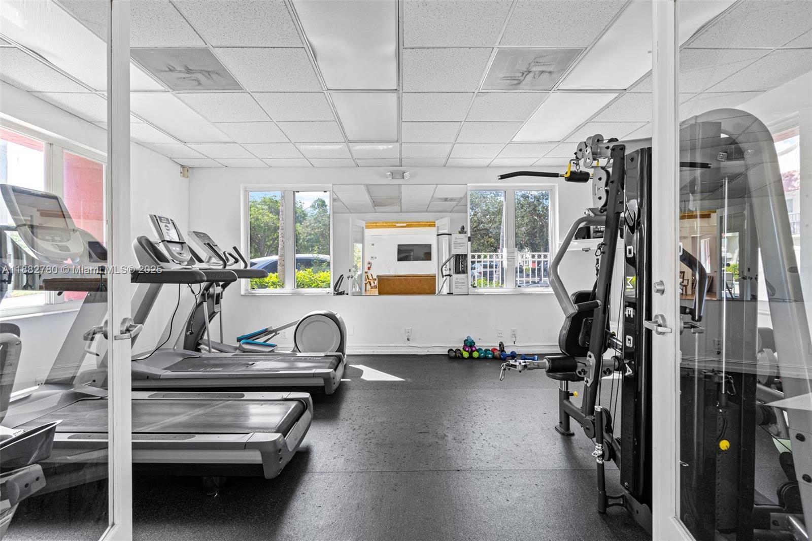 8650 Southwest 67th Avenue, Unit 1027 Pinecrest, FL 33156 - Photo 30 of 41 a view of a room with gym equipment