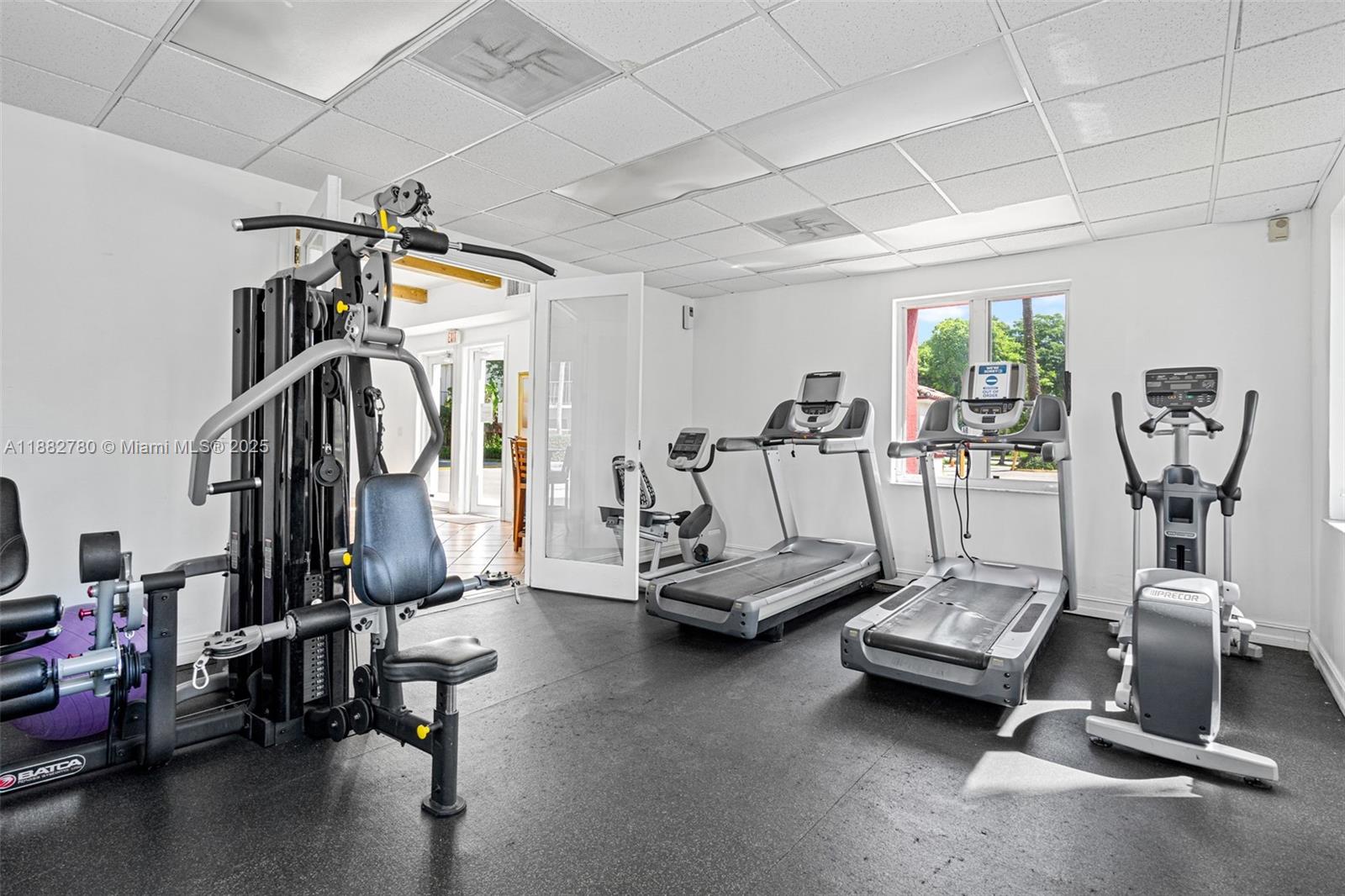 8650 Southwest 67th Avenue, Unit 1027 Pinecrest, FL 33156 - Photo 31 of 41 a view of a room with gym equipment
